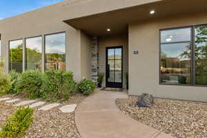 Property entrance featuring stucco siding