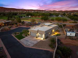 Aerial view of property and surrounding area featuring a mountain backdrop