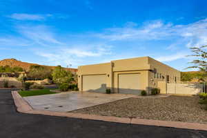 View of front of house with concrete driveway, a garage, and stucco siding