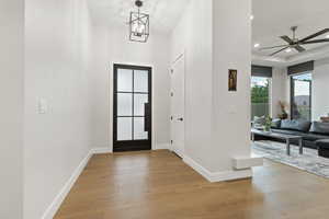 Entryway featuring light wood-style floors, recessed lighting, a ceiling fan, and a chandelier