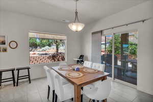 Dining area featuring light tile patterned flooring
