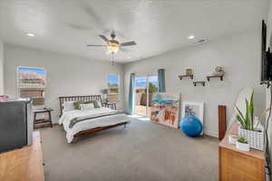Bedroom featuring access to outside, a textured ceiling, recessed lighting, a ceiling fan, and carpet floors