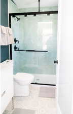 Bathroom featuring a stall shower, vanity, and tile patterned floors