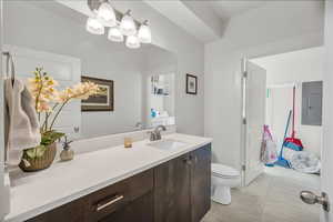 Bathroom featuring vanity, electric panel, and light tile patterned floors