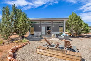 Rear view of property featuring a patio area and an outdoor living space