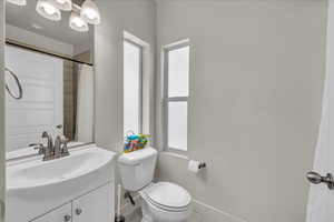 Full bathroom with vanity, tile patterned flooring, and curtained shower