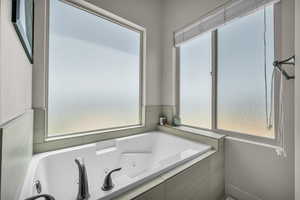 Full bathroom with a jetted tub