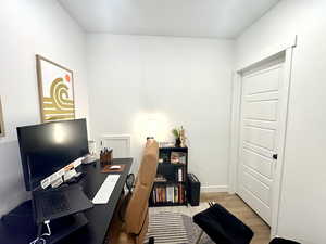 Home office featuring light wood finished floors and baseboards