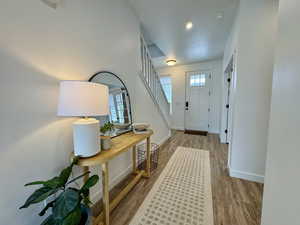 Entryway with stairs, light wood-type flooring, and recessed lighting