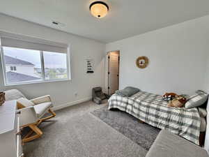 Carpeted bedroom with baseboards