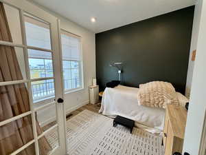 Bedroom featuring wood finished floors and baseboards