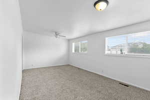 Spare room with carpet floors and ceiling fan