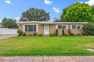 Single story home featuring brick siding