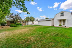 View of green lawn with a garage