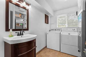 Laundry area with washing machine and dryer and baseboards
