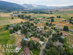 Aerial view of property and surrounding area with a mountain backdrop and rural landscape