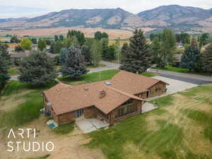 Aerial view of property and surrounding area with a mountainous background