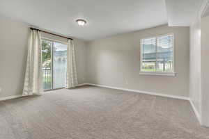 Spare room featuring light colored carpet