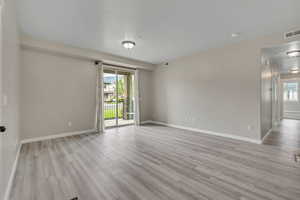 Spare room with light wood-type flooring and baseboards