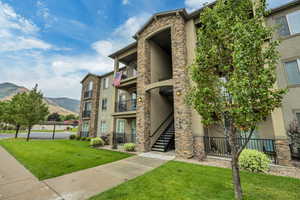 View of property featuring a mountain view and stairs