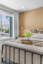 Carpeted bedroom with a mountain view and a textured ceiling