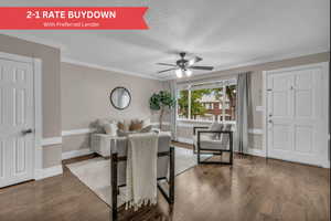 Living room with dark wood-style flooring, ornamental molding, a ceiling fan, and a textured ceiling