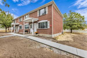 Colonial inspired home featuring brick siding