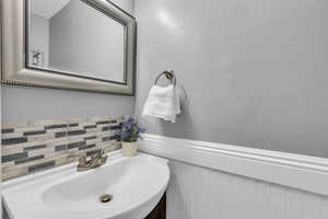 Bathroom featuring a wainscoted wall and vanity