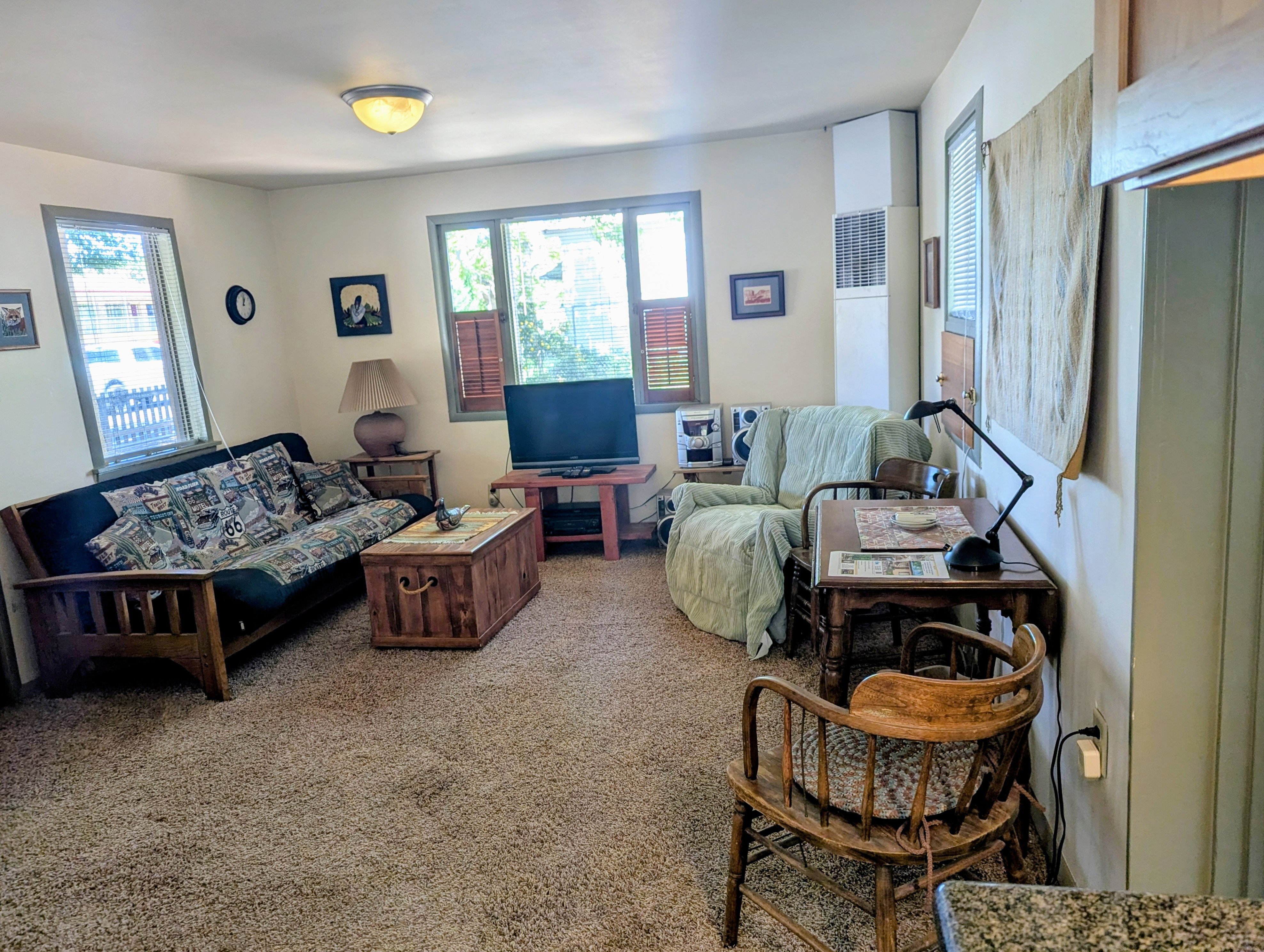 Living room featuring carpet floors and a heating unit