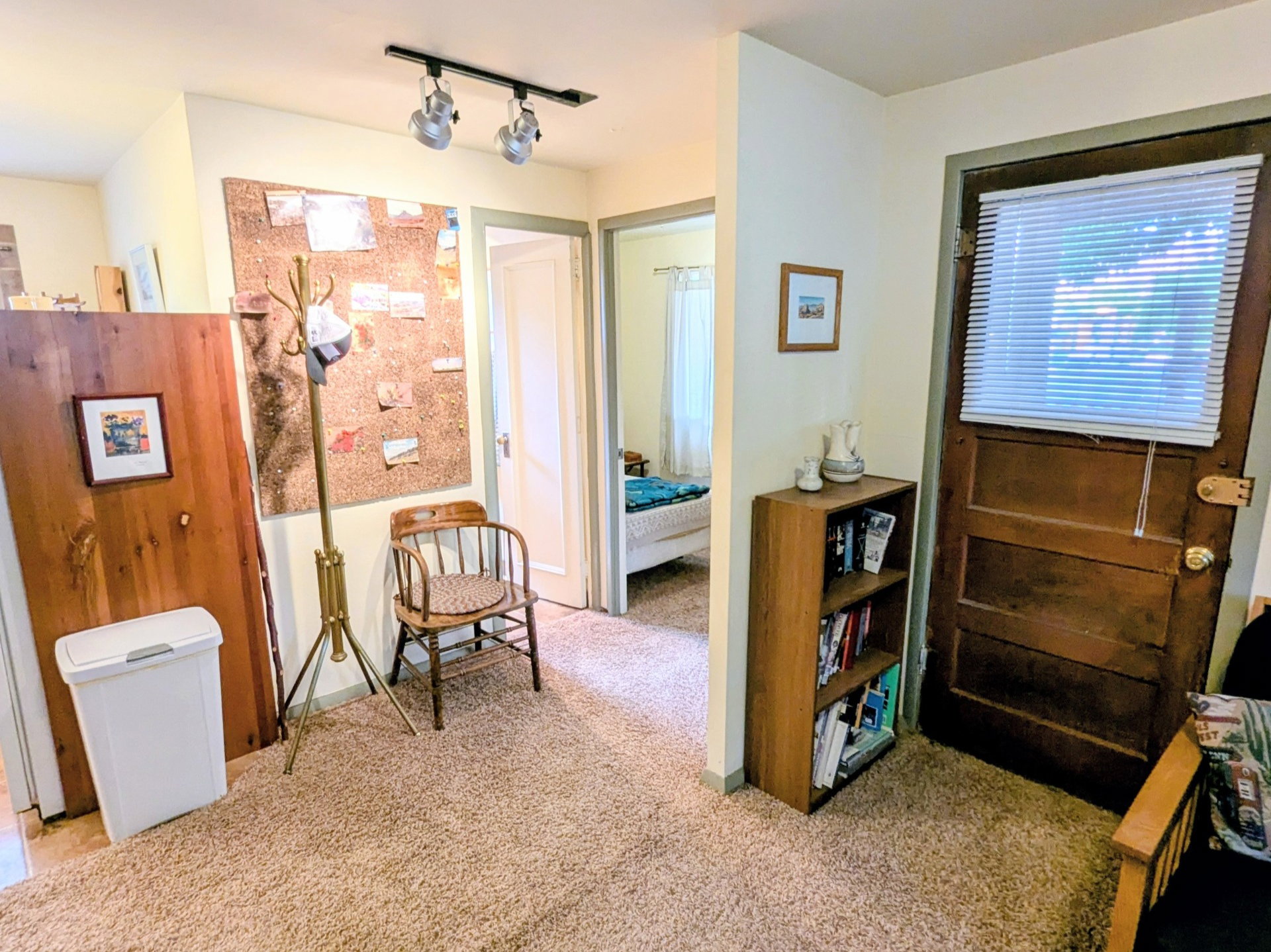 Sitting room with carpet floors and track lighting
