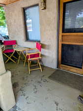 View of exterior entry with stucco siding