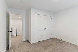Unfurnished bedroom featuring carpet, a closet, and recessed lighting
