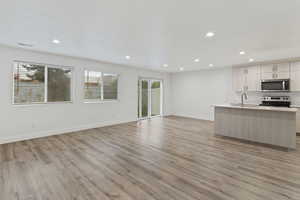 Unfurnished living room featuring light wood-style flooring and recessed lighting