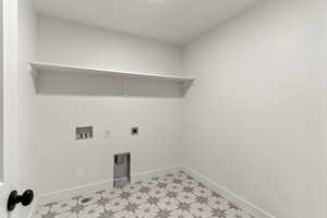 Laundry room featuring hookup for a washing machine, electric dryer hookup, and light floors