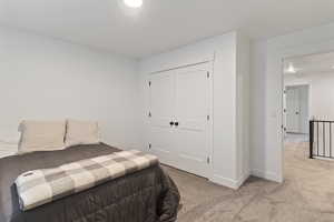 Bedroom with carpet flooring and a closet