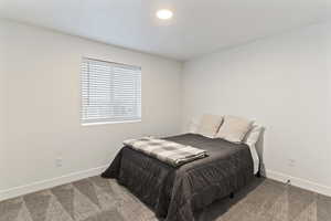 Carpeted bedroom featuring baseboards and recessed lighting