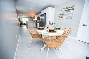 Dining room featuring light tile patterned floors and recessed lighting