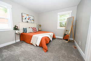 Carpeted bedroom with baseboards