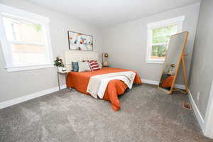 Bedroom with carpet flooring and baseboards