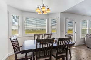 Dining room featuring a chandelier and light tile patterned flooring