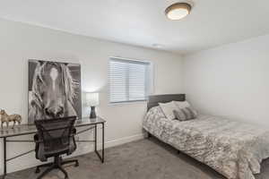 Bedroom with carpet floors and a desk