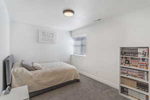 Bedroom with carpet flooring and baseboards