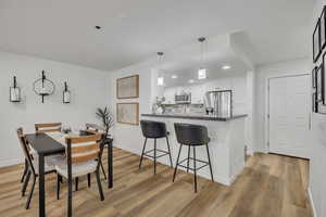 Dining space featuring recessed lighting and light wood-style flooring