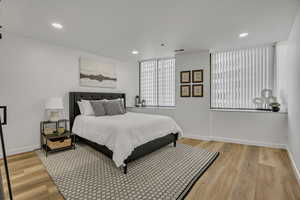 Bedroom with light wood-type flooring and recessed lighting