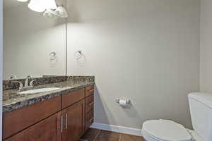 Bathroom featuring vanity and dark tile patterned flooring