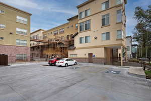 View of property featuring uncovered parking