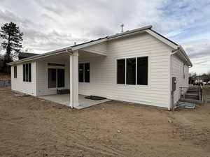 Back of house with a patio