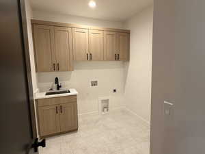 Laundry area featuring cabinet space, hookup for a washing machine, electric dryer hookup, and recessed lighting