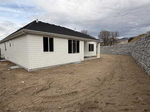 Back of property with a patio area, a fenced backyard, and roof with shingles