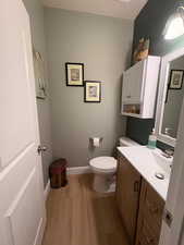 Half bath featuring light wood-style floors and vanity